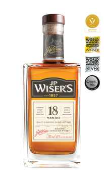 J.P. Wiser’s 18 Year Old Canadian Whisky 750ml bottle on a white background, featuring a clear glass design with a wooden cap and a premium cream, black and gold label. The label highlights the 18-year aging and Canadian whisky branding. The whisky inside has a rich amber hue. Aged Canadian whisky crafted in Ontario with notes of autumn florals, green apple, fresh pine, caramel, spice, and oak—ideal for sipping neat or with a splash of water.