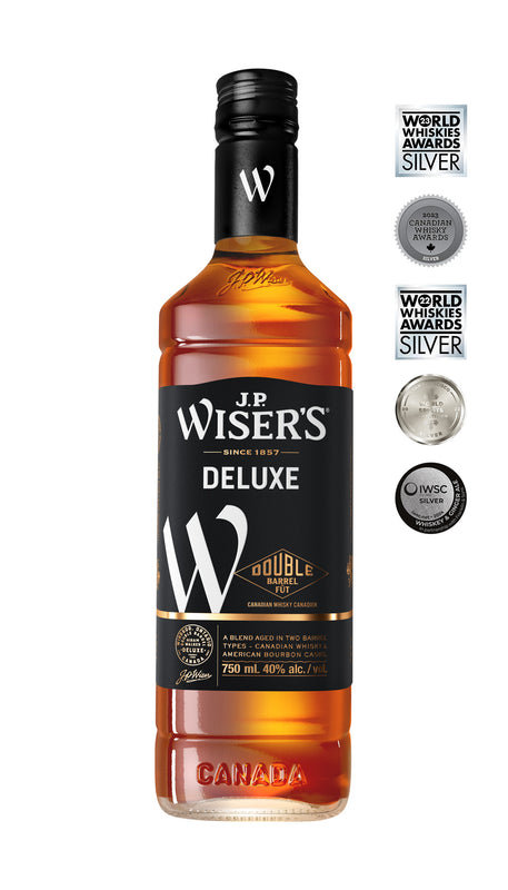 .P. Wiser’s Deluxe Canadian Whisky 750ml bottle on a white background, featuring a clear glass design with a black cap and a gold-accented label displaying the brand name and product details. The amber whisky inside is visible, highlighting its rich color. Premium Canadian whisky for sipping or mixing.